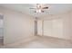 Bedroom with ceiling fan, carpet flooring, and double door closet at 10407 W Desert Forest Cir, Sun City, AZ 85351