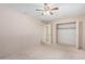 Bedroom with ceiling fan, carpet, and mirrored closet doors at 10407 W Desert Forest Cir, Sun City, AZ 85351