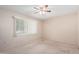 Well-lit bedroom with ceiling fan and window coverings at 10407 W Desert Forest Cir, Sun City, AZ 85351