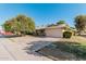 Single-story home with attached garage and driveway at 10407 W Desert Forest Cir, Sun City, AZ 85351