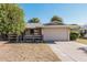 Single story home with attached garage and mature landscaping at 10407 W Desert Forest Cir, Sun City, AZ 85351