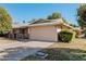 Single-story home with attached garage and well-maintained landscaping at 10407 W Desert Forest Cir, Sun City, AZ 85351