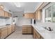 Kitchen with wood cabinets, white countertops, and stainless steel appliances at 10407 W Desert Forest Cir, Sun City, AZ 85351