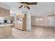 Open kitchen with wood cabinets, and a view into the adjacent living area at 10407 W Desert Forest Cir, Sun City, AZ 85351