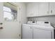 Laundry room with washer, dryer, and cabinets at 10407 W Desert Forest Cir, Sun City, AZ 85351