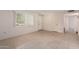 Simple living room with tile floors and neutral colors at 10407 W Desert Forest Cir, Sun City, AZ 85351