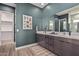 Double vanity bathroom with modern dark brown cabinets and a walk-in shower at 11054 E Utopia Ave, Mesa, AZ 85212