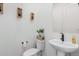 Simple half bathroom with pedestal sink and toilet at 11054 E Utopia Ave, Mesa, AZ 85212