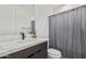 Modern bathroom with marble vanity, gray shower curtain, and black fixtures at 11054 E Utopia Ave, Mesa, AZ 85212