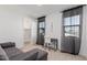 Well-lit bedroom with a desk and built-in closet at 11054 E Utopia Ave, Mesa, AZ 85212