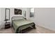 Guest bedroom with a metal framed bed and light green bedding at 11054 E Utopia Ave, Mesa, AZ 85212