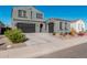 Two-story home with gray exterior, two-car garage, and landscaping at 11054 E Utopia Ave, Mesa, AZ 85212