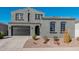 Two-story home with gray exterior, two-car garage, and landscaping at 11054 E Utopia Ave, Mesa, AZ 85212