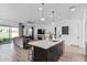 Modern kitchen with island, stainless steel appliances, and dark cabinets at 11054 E Utopia Ave, Mesa, AZ 85212