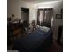 Bright bedroom with a double bed, window, and closet at 12103 W Rosewood Dr, El Mirage, AZ 85335