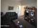 Cozy living room featuring a sofa, coffee table, and built-in shelving at 12103 W Rosewood Dr, El Mirage, AZ 85335