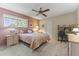 Spacious bedroom with a queen-size bed and built-in desk at 13416 N Cedar Dr, Sun City, AZ 85351