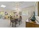 Bright dining area with wood table and chairs, adjacent to living room at 13416 N Cedar Dr, Sun City, AZ 85351