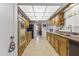 Galley style kitchen with wood cabinets and ample counter space at 13416 N Cedar Dr, Sun City, AZ 85351