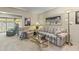 Relaxing living room with striped sofa, glass coffee table, and floor lamp at 13416 N Cedar Dr, Sun City, AZ 85351