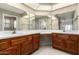 Bathroom with double vanity and wood cabinets at 13907 W Terra Vista Dr, Sun City West, AZ 85375