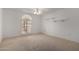 Bedroom with arched window and ceiling fan at 13907 W Terra Vista Dr, Sun City West, AZ 85375