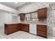 Kitchen with wood cabinets, tile floors, and island at 13907 W Terra Vista Dr, Sun City West, AZ 85375