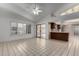 Living room with tile floor, kitchen access, and view to patio at 13907 W Terra Vista Dr, Sun City West, AZ 85375