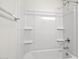 Clean bathroom with bathtub, shower, and shelving at 1402 W Hess Ave, Coolidge, AZ 85128