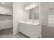 Double vanity bathroom with a large mirror and built-in shelving at 1402 W Hess Ave, Coolidge, AZ 85128