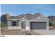 Single-story home with gray exterior and two-car garage at 1402 W Hess Ave, Coolidge, AZ 85128