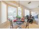 Bright breakfast nook features a glass table and four chairs, offering a casual dining space at 14309 W Rico Dr, Sun City West, AZ 85375