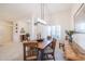 Formal dining room with a rustic wooden table and chairs, along with a sideboard at 14309 W Rico Dr, Sun City West, AZ 85375