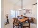 Formal dining room with a rustic wooden table and chairs, and a statement light fixture at 14309 W Rico Dr, Sun City West, AZ 85375