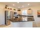 Modern kitchen with stainless steel appliances and a large granite island at 14309 W Rico Dr, Sun City West, AZ 85375