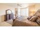 Spacious main bedroom with a king-size bed and large windows at 14309 W Rico Dr, Sun City West, AZ 85375