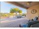 Relaxing covered patio with seating area and beautiful yard views at 14309 W Rico Dr, Sun City West, AZ 85375