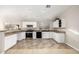 Modern kitchen featuring white cabinets and stainless steel appliances at 1434 E Detroit St, Chandler, AZ 85225