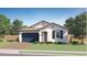 Single-story home with a blue garage door and landscaping at 1434 W Ridge Rd, Apache Junction, AZ 85120