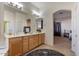 Bathroom with double sinks and a view into bedroom at 14848 W Edgemont Ave, Goodyear, AZ 85395