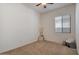 Bright bedroom with carpet flooring, window, and ceiling fan at 14848 W Edgemont Ave, Goodyear, AZ 85395