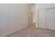 Simple bedroom with double door closet and carpet at 14848 W Edgemont Ave, Goodyear, AZ 85395