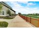 Walking path in a community with a grassy area and modern building at 14848 W Edgemont Ave, Goodyear, AZ 85395