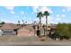 Two-story home with a three-car garage and palm trees at 14848 W Edgemont Ave, Goodyear, AZ 85395