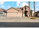 Two-story home with a three-car garage and palm trees at 14848 W Edgemont Ave, Goodyear, AZ 85395