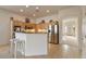 Modern kitchen with island, stainless steel appliances, and light wood cabinets at 14848 W Edgemont Ave, Goodyear, AZ 85395