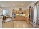 Spacious kitchen with light wood cabinets and stainless steel appliances at 14848 W Edgemont Ave, Goodyear, AZ 85395