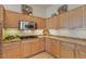 Well-equipped kitchen with light wood cabinets and granite countertops at 14848 W Edgemont Ave, Goodyear, AZ 85395