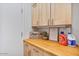 Laundry room with wooden cabinets and countertop at 14848 W Edgemont Ave, Goodyear, AZ 85395