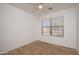 Bright bedroom with wood-look tile flooring and window blinds at 15819 W Crocus Dr, Surprise, AZ 85379